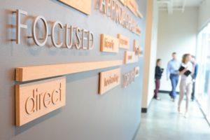 Brighton Jones interns word wall in office