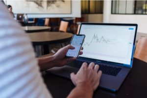 iso vs nso man reviewing stock charts on phone and computer