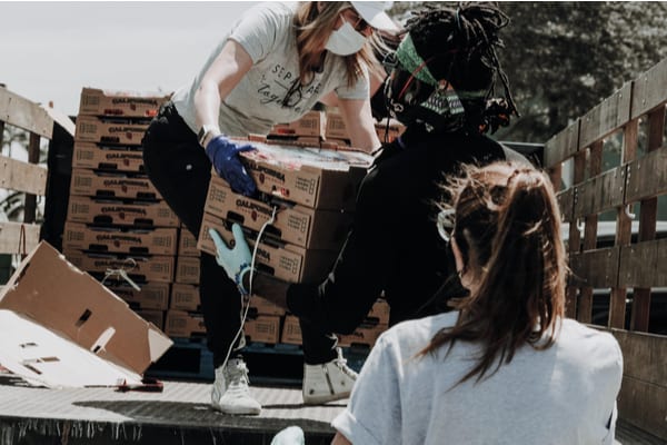 recoverable grants women doing charity work at a food bank