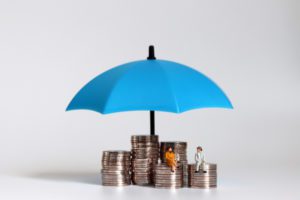 group vs. individual life insurance couple enjoying financial security under umbrella