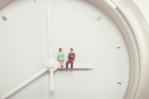 couple sitting on a clock financial compatibility