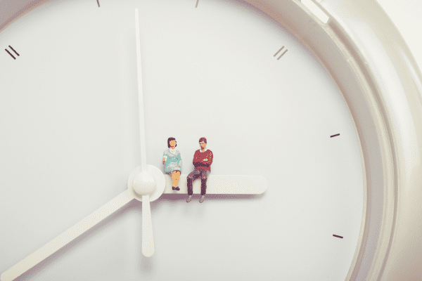 couple sitting on a clock financial compatibility
