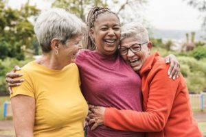 three friends embracing women financial confidence