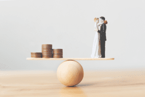 combining finances before marriage couple on a scale opposite money