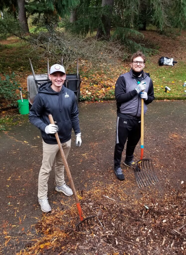 Two volunteers spread mulch at Washington Arboretum in Seattle